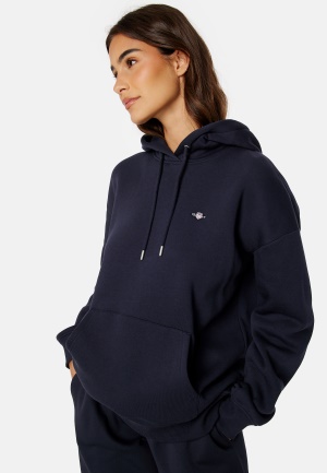 Se GANT Rel Shield Hoodie EVENING BLUE XS ved Bubbleroom